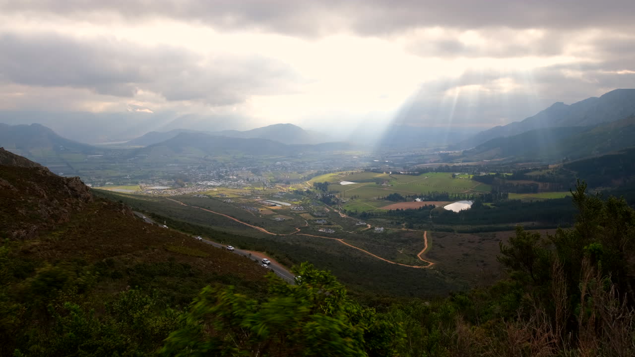 Heavenly god rays or crepuscular rays illuminate Franschhoek valley dramatically