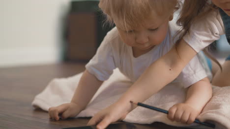 little blond toddler lies on floor