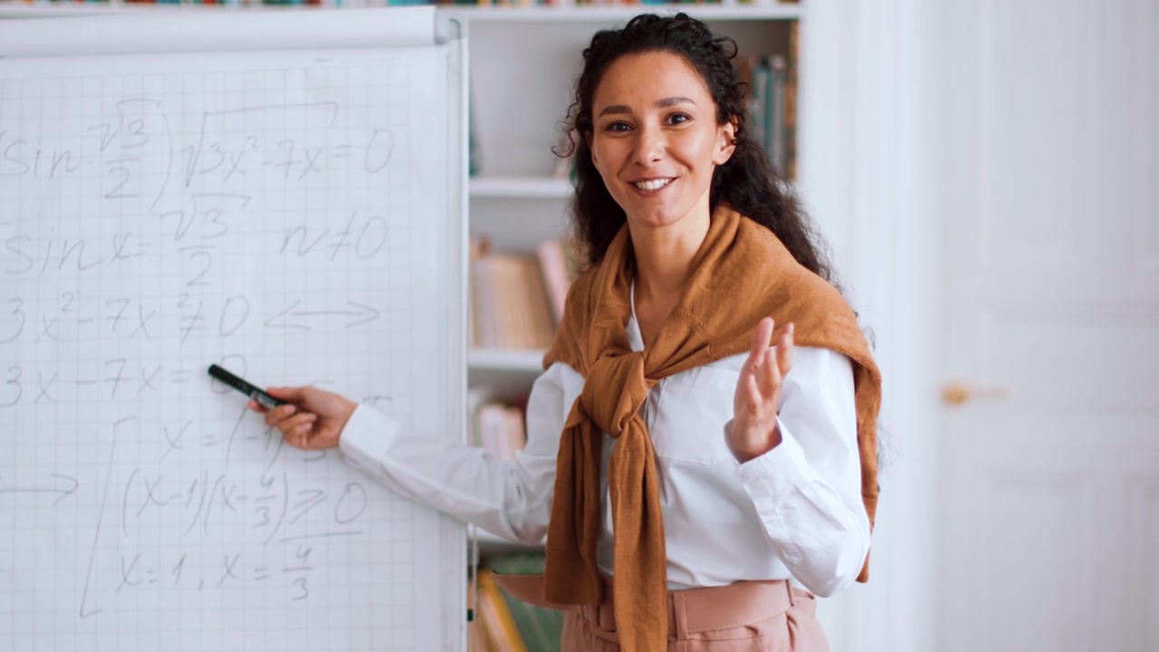 Female Teacher Explaining Mathematical Equations on Whiteboard