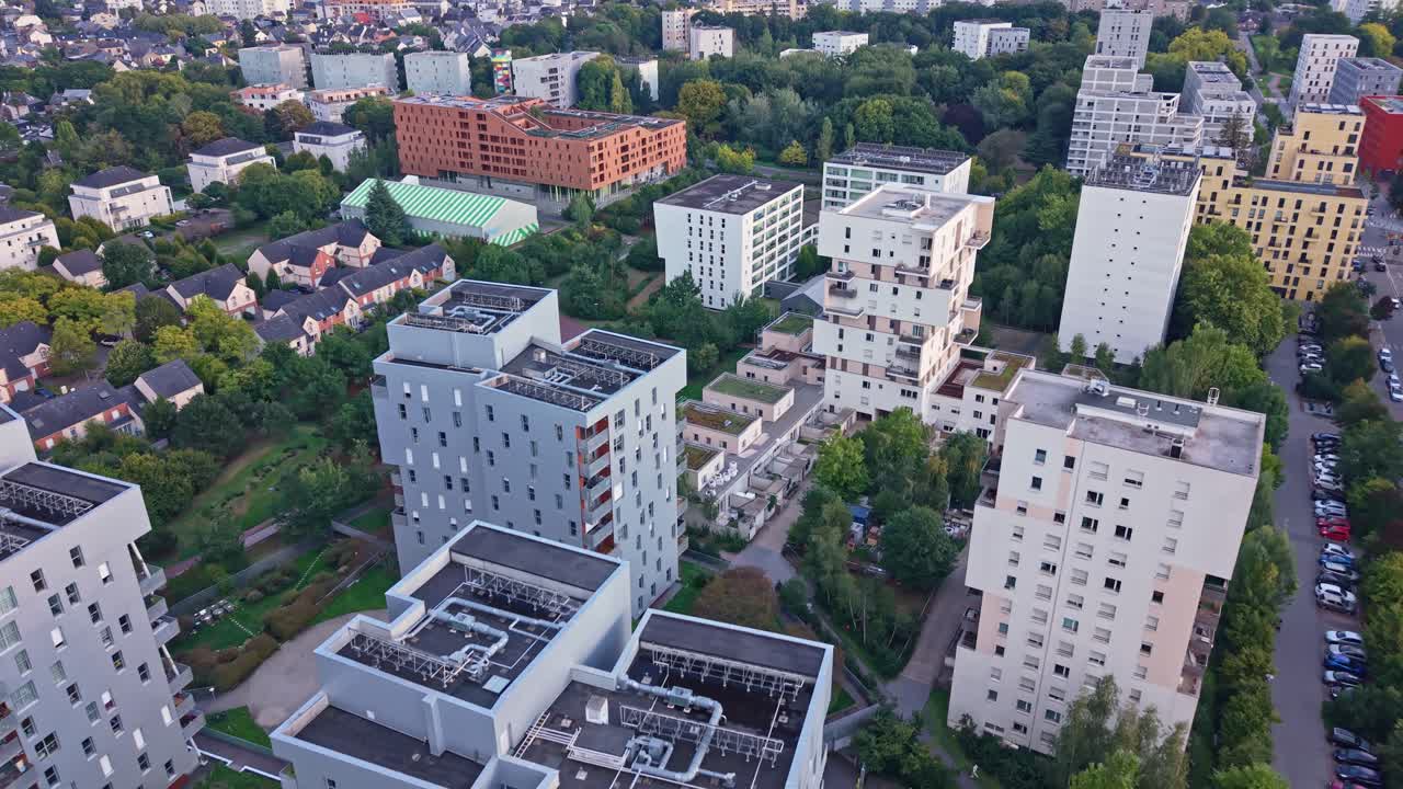 Aerial drone view of the La Courrouze eco-district in Rennes, France. Modern residential apartment buildings surrounded by green parks and trees in a sustainable urban development