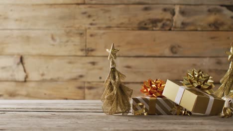 Video-of-christmas-gifts-with-christmas-tree-decoration-and-copy-space-on-wooden-background