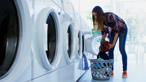 Woman-putting-clothes-into-washing-machine-4k