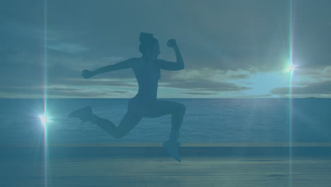 animation of light trails caucasian woman running at beach