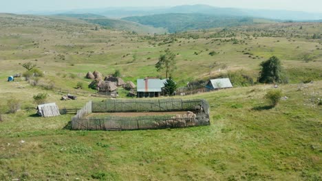 animal farming with cottages on scenic green mountains at countryside