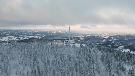 winter-drone-orbit-move-around-the-Radhost-chappel-during-golden-hour-part2,-Beskydy-4k