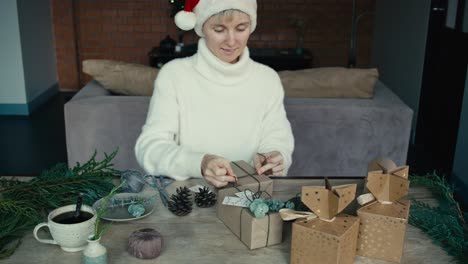 woman wrapping christmas gifts at home