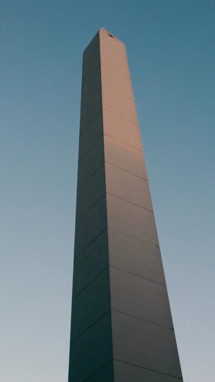 Low angle view of Monumental Obelisk, landmark building over Sunset Skyline, Vertical view