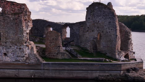 aerial pan right shot of ruins of koknese castle on banks of daugava river, latvia