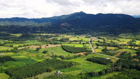 aerial view of beautiful sky road over top of mountains with green jungle in nan province, thailand