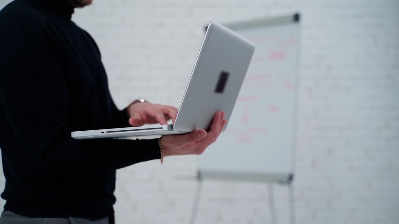 Young professional businessman. Close up of male hands typing on notebook