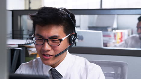 young asian man working in a call centre