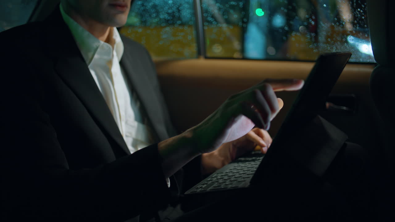 Businessman hand tapping tablet screen car closeup. Manager working pad device