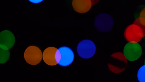 shimmering abstract colored circles defocused christmas lights background. blurred fairy lights. out of focus holiday background christmas tree. light bokeh from xmas tree. xmas and new year theme. 4k video