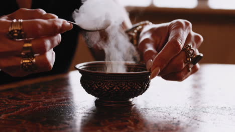 woman performing a ritual with incense