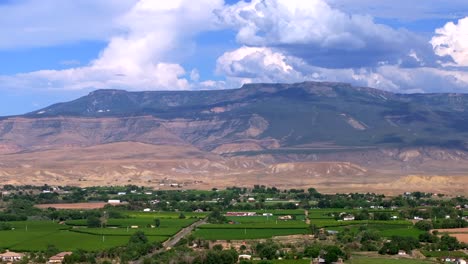 grand mesa grand junction aerial drone afternoon cloudy colorado river summer blue sky wine vineyards parachute fruitvale mt garfield western close delta downtown main street backward motion