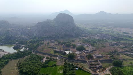 timeless fort hill surrounded by historical structures and forested plains near gingee