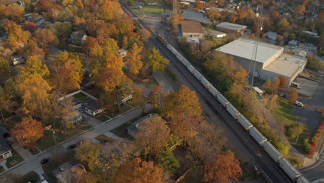 aerial view of a freight train pulling down the tracks through kirkwood in st