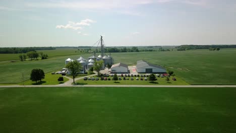 aerial view descending to rural farm with grain silo storage, arcadia, indiana farming landscape