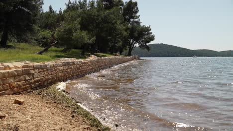 foundation walls of a roman villa next to coastline suffering from water erosion