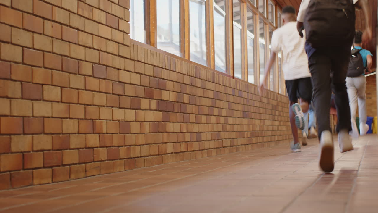 Running in school hallway, students with backpacks heading to class, copy space