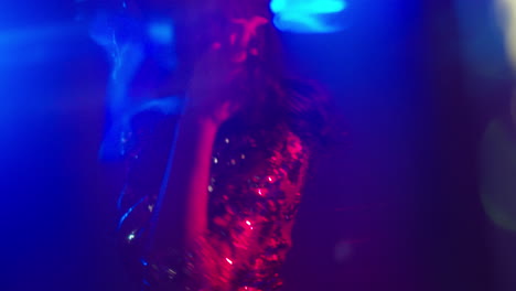 close up of woman in nightclub bar or disco dancing with sparkling lights 2