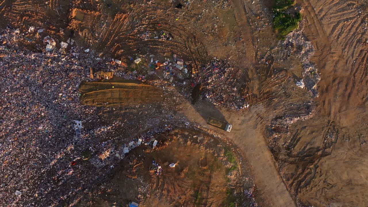 Drone perspective of a polluted landfill with mounds of rubbish