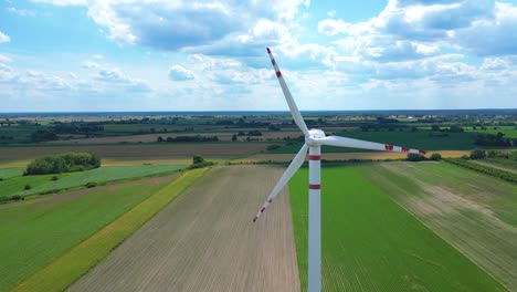 Panoramic-view-of-wind-farm-or-wind-park,-with-high-wind-turbines-for-generation-electricity-with-copy-space