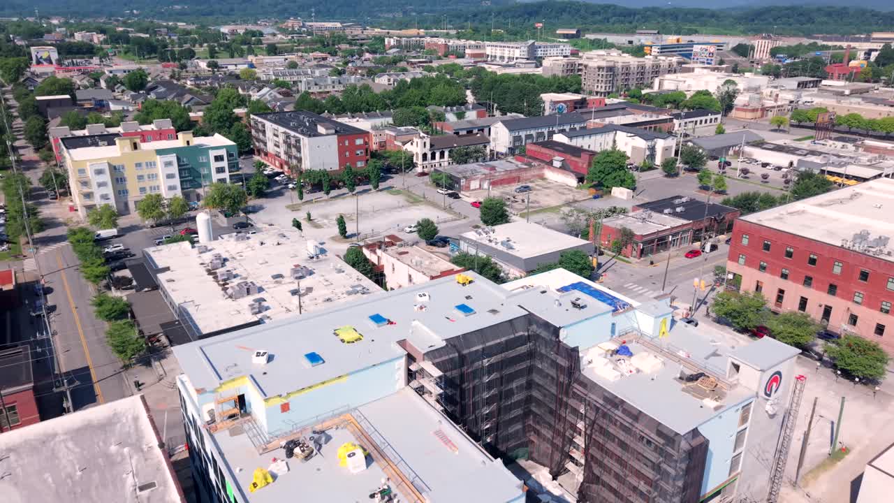 Chattanooga's urban neighborhood with modern and traditional architecture at daytime in Tennessee. A blend of colorful residential and business areas - Aerial flyover