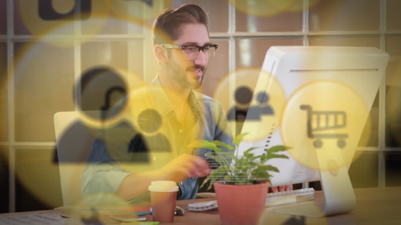 Animation of media icons over businessman using computer