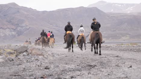 tourist riding horses in thórsmörk valley in iceland, recreational activity