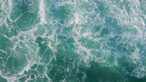 top rough sea surface waving with foam. aerial shot stormy ocean waves rippling.