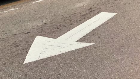 An-arrow-roadsign-for-one-way-street-during-daytime