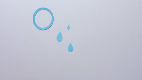 hands of caucasian woman holding glucometer over blue drops and circle on grey, slow motion