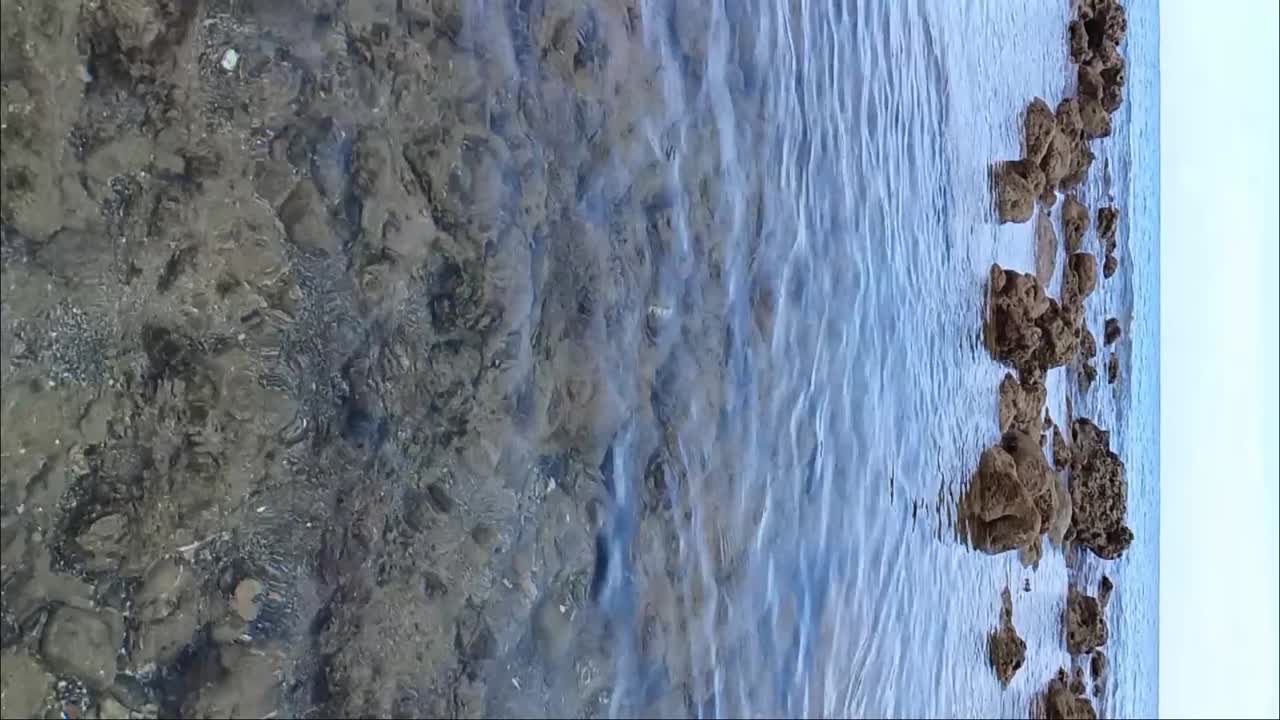 Clear water of Tanjung Losa Beach in Mamuju, West Sulawesi, Indonesia. Slow motion shot.