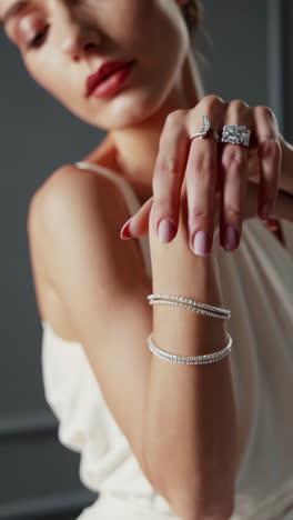elegant woman showcasing luxury diamond rings and jewelry