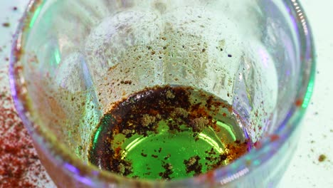 Macro-shot-of-golden-powder-turning-black-with-chemical-reaction