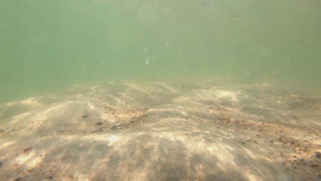 Underwater-View-Of-Sandy-Sea-Beach-Bottom