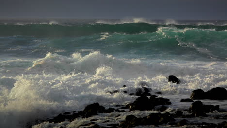 big waves roll into a beach following a big storm in slow motion 1