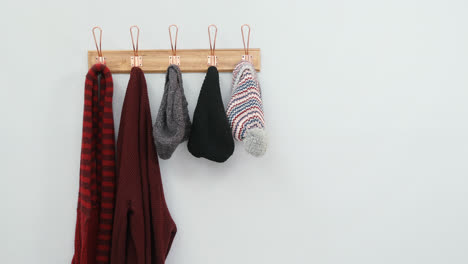 Warm-clothes-hanging-on-hook-4k