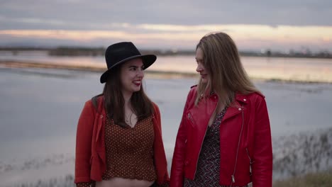 two women enjoying a sunset stroll