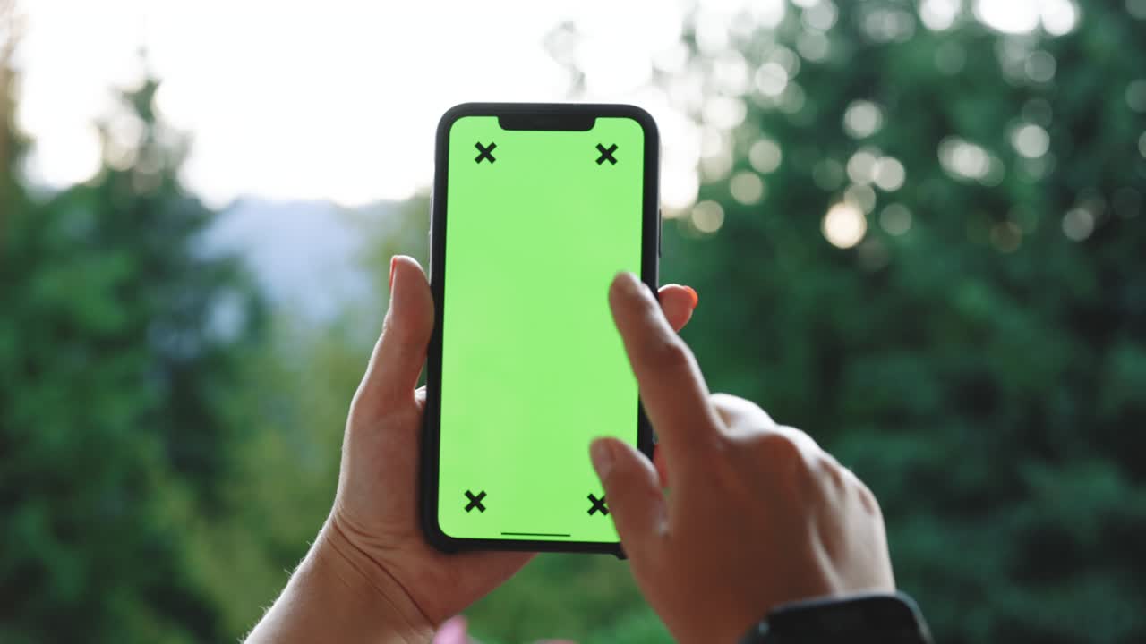 Woman's hand holding mobile telephone with vertical green screen in tram chroma key smartphone technology cell phone touch message display hand Using Mobile Phone Browsing Internet Watching Content