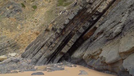 tectonic volcaninc plates in the beach of gruta da adraga in portugal