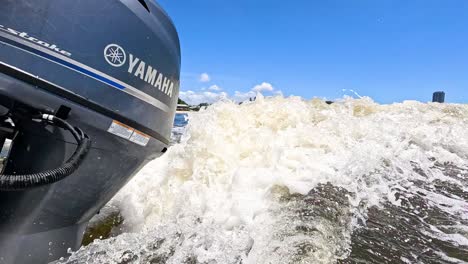 speedboat creating waves on a sunny day