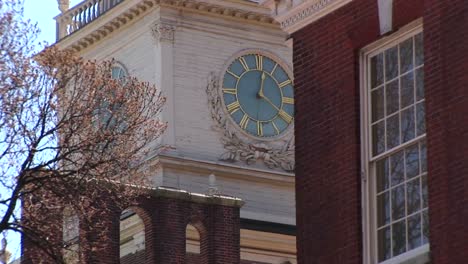 the camera pans up to the charming ornate clock tower on independence hall