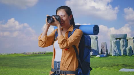 happy tourist taking photos at stonehenge