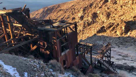 keane wonder mine ruins at death valley national park from above at sunset with light snow in winter