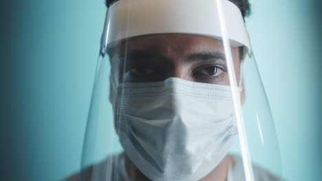 portrait of middle eastern doctor in face shield and mask