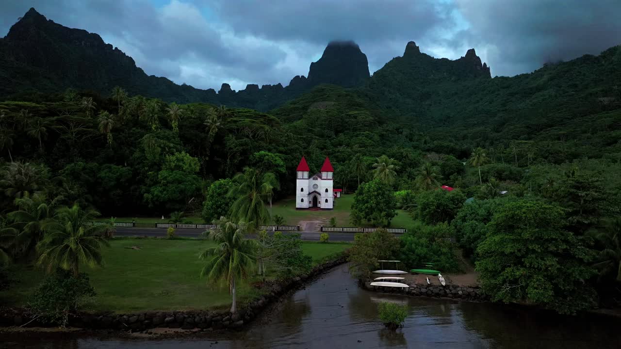 Eglise de la Sainte Famille Catholic Church of the Holy Family Moorea Mo'orea French Polynesia drone aerial Tahiti Pacific Island Catholic historic building Temple of Papetoa dark cloudy moody static