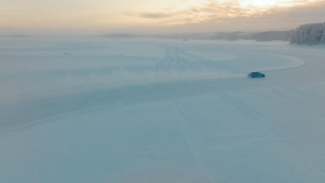 Norbotten-driver-drifting-on-frozen-Lapland-ice-lake-at-sunrise-aerial-view