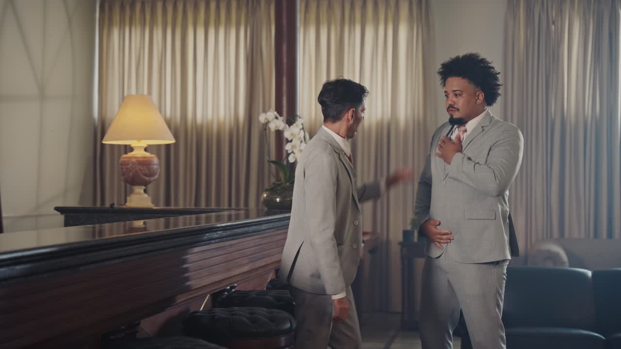 Two Well-Dressed Men Socializing and Enjoying Drinks at a Bar